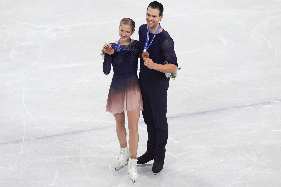 Feb 16, 2026; Milan, Italy;  Minerva Fabienne Hase and Nikita Volodin of Germany celebrate with their bronze medals in the pairs free skate during the Milano Cortina 2026 Olympic Winter Games at Milano Ice Skating Arena. Mandatory Credit: Amber Searls-Imagn Images