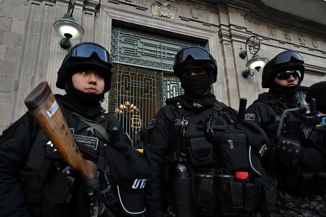 Riot police standing guard outside the government palace in La Paz, on June 27, following an attempt by a military movement to seize it by force.