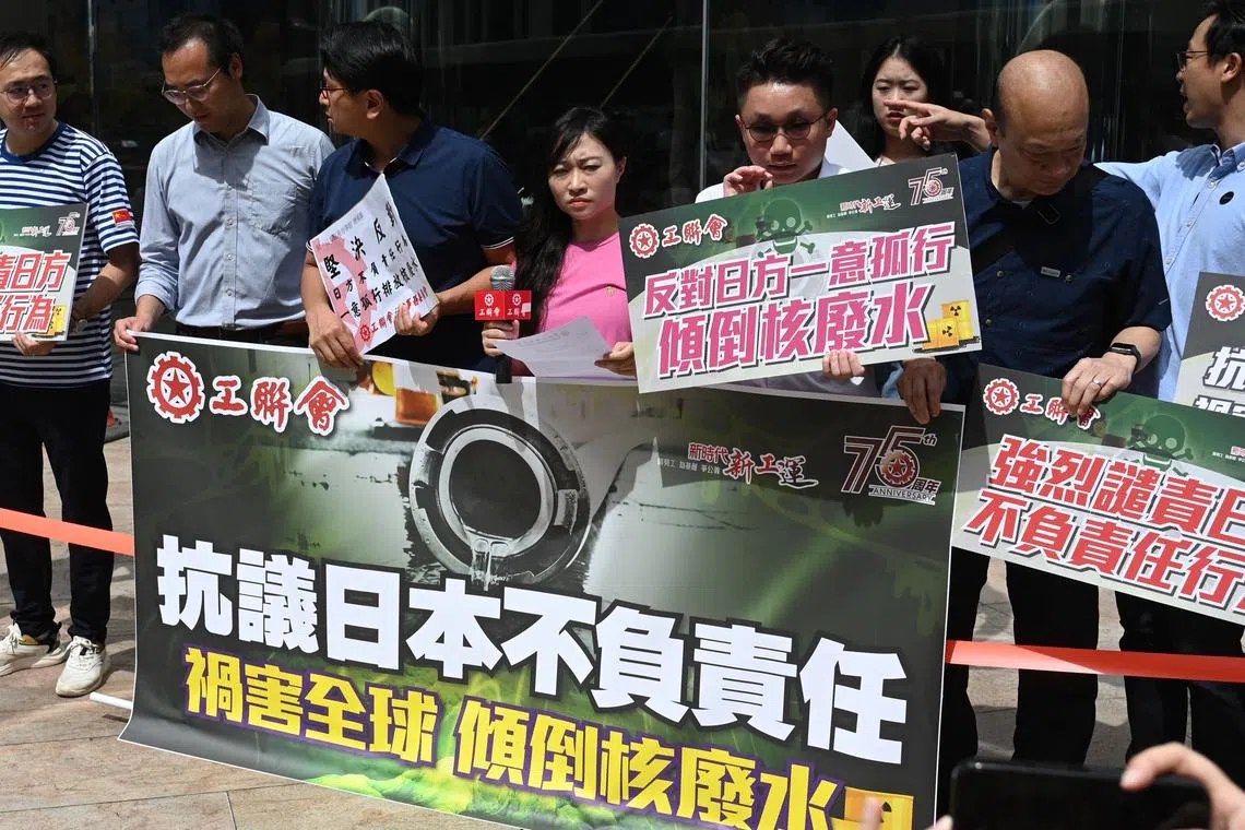 Members of the Hong Kong Federation of Trade Unions protest outside the Japanese consulate in Hong Kong, on Aug 22.