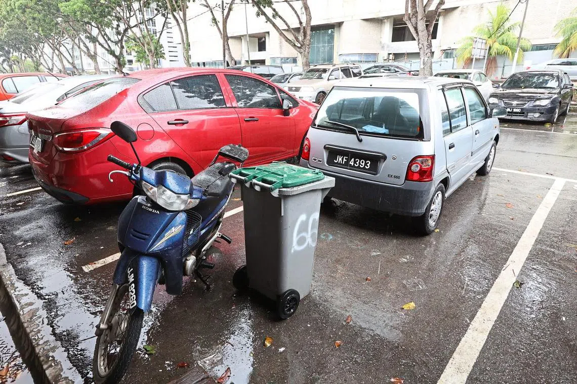 Some business owners in Jalan Storey, Johor Bahru, are using trash bins to stop drivers from parking in front of their premises for days on end. Many of these drivers left their cars there before commuting to Singapore for work. 