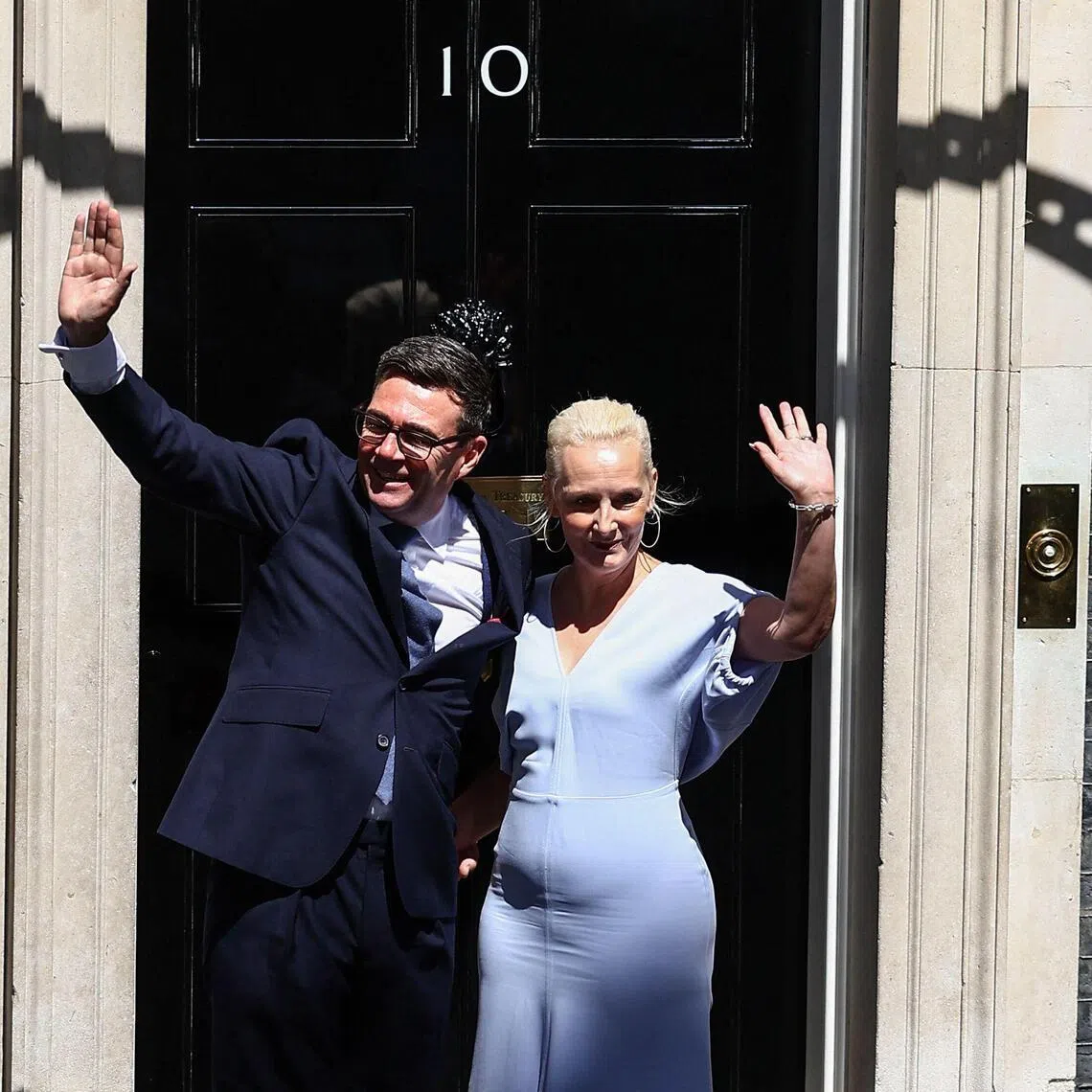 Britain's new Prime Minister Andy Burnham and his wife Marie-France van Heel pose on the steps of 10 Downing Street in central London on July 20, 2026, after being asked by the king to form the next government. (Photo by Peter Nicholls / AFP)