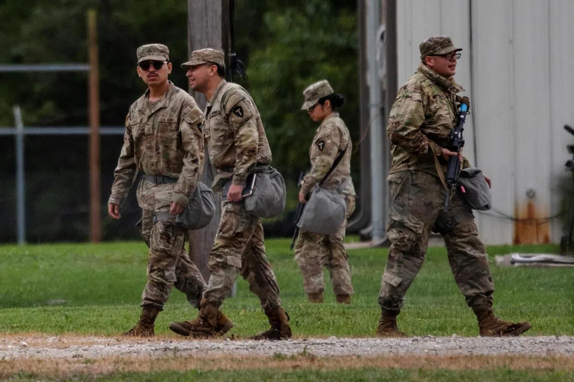 Texas National Guard troops walk through the Joliet Army Reserve Training Center, after U.S. President Donald Trump ordered increased federal law enforcement presence to assist in crime prevention, in Elwood, Illinois, U.S., October 7, 2025.  REUTERS/Jim Vondruska     TPX IMAGES OF THE DAY     