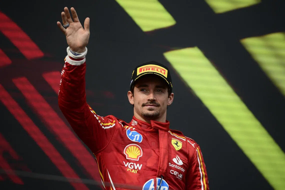 FILE PHOTO: Formula One F1 - Emilia Romagna Grand Prix - Autodromo Enzo e Dino Ferrari, Imola, Italy - May 19, 2024 Ferrari's Charles Leclerc waves from the podium after finishing third in the Emilia Romagna Grand Prix REUTERS/Massimo Pinca