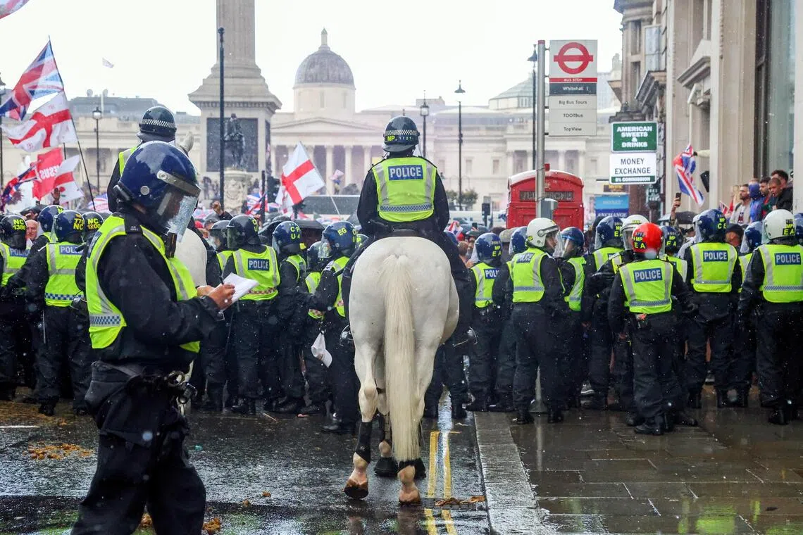 British police trying to prevent protesters veering from the route faced “unacceptable violence”, the force said. 