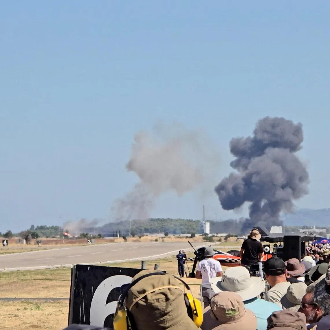 Smoke rising after a Greek two-seat F-4 Phantom fighter jet crashed during an air show at Tanagra air base north of Athens on Sept 5.