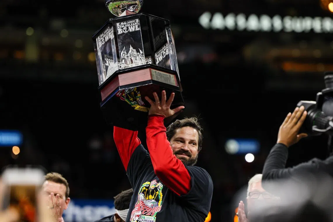 FILE PHOTO: Dec 18, 2021; New Orleans, LA, USA;  Louisiana-Lafayette Ragin Cajuns head coach Michael Desormeaux raises the trophy to the crowd against Marshall Thundering Herd after the game at the 2021 New Orleans Bowl at Caesars Superdome. Mandatory Credit: Stephen Lew-USA TODAY Sports/File photo