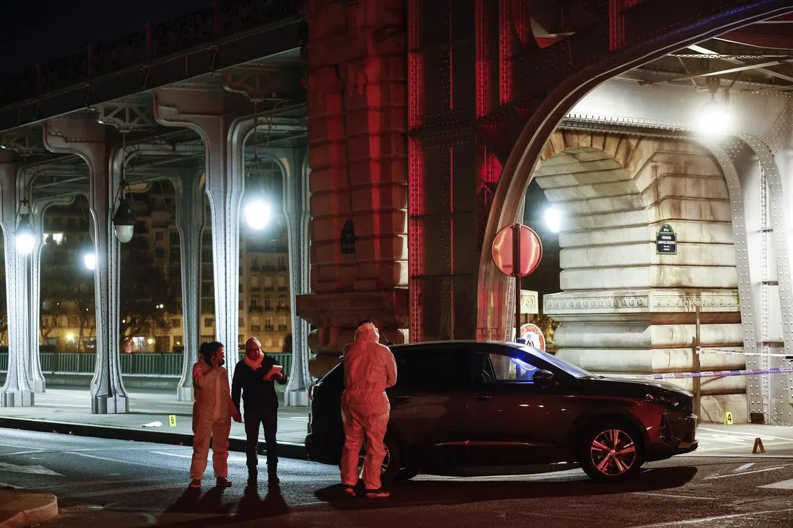 French forensic policemen investigate the scene following a knife attack in Paris on Dec 3. EPA