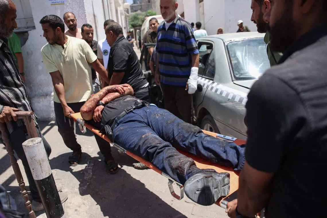 Palestinians transporting casualties of a reported Israeli strike to Gaza City's Al-Ahli hospital, on June 5.
