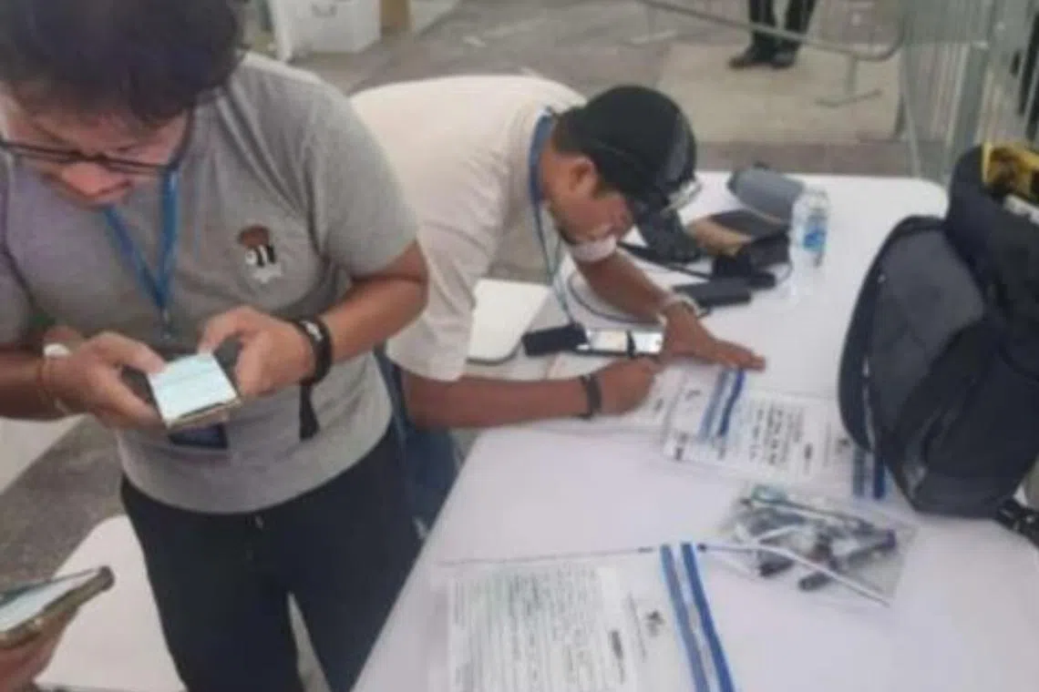 Health Sciences Authority officers conducting an operation at ZoukOut 2023, where some 176 people were caught using e-vaporisers.