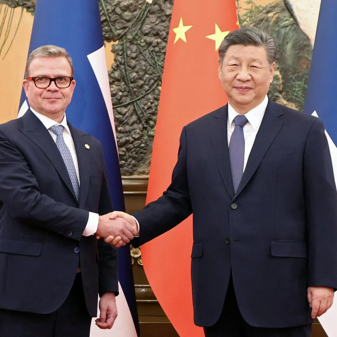 Chinese President Xi Jinping and Finland's Prime Minister Petteri Orpo shake hands at the Great Hall of the People in Beijing, China January 27, 2026. China Daily via REUTERS