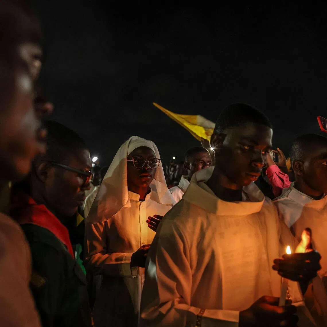 Altar servers lead a night vigil on the fifth day of Pope Leo’s 11-day visit to Africa in Yaounde, Cameroon. 
