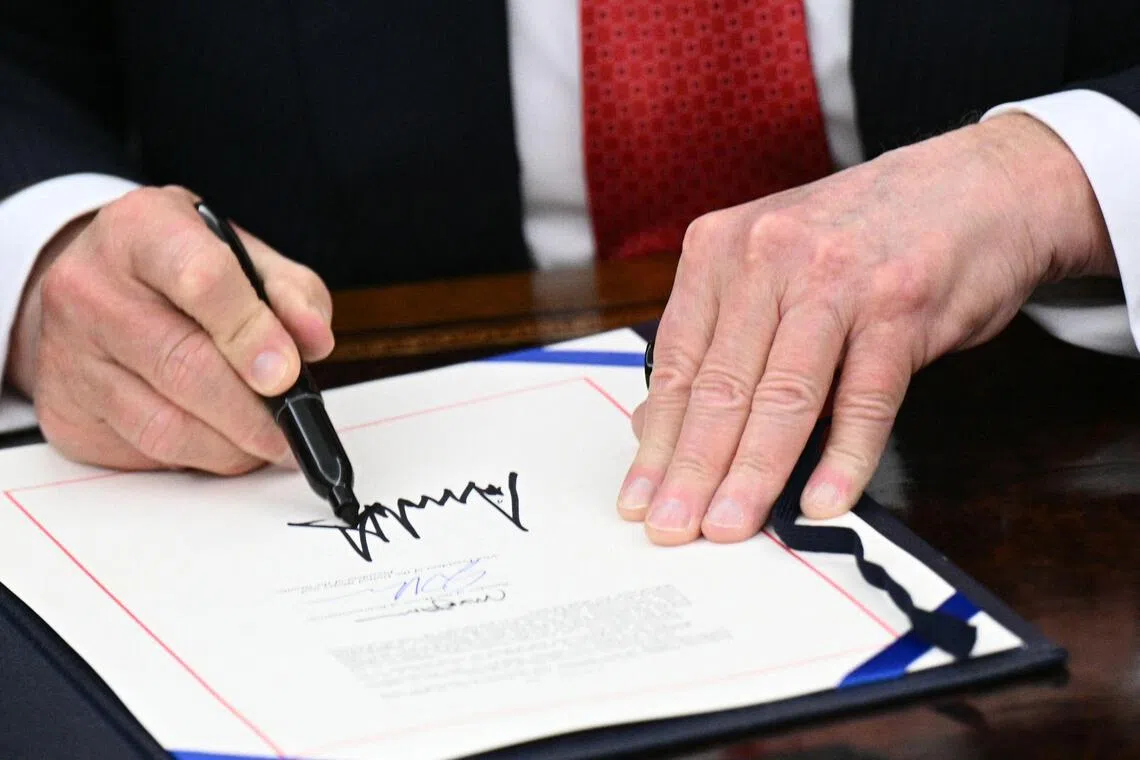 US President Donald Trump signing a Bill package to re-open the federal government  on Nov 12. 