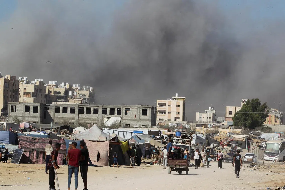 Smoke rising following an Israeli strike on a residential building in Khan Younis, in the southern Gaza Strip, on Aug 16.