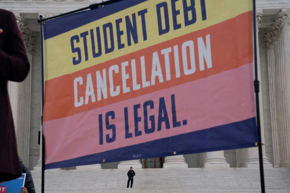 FILE PHOTO: A law enforcement officer watches as supporters of student loan debt relief rally in front of the Supreme Court as the justices are scheduled to hear oral arguments in two cases involving President Joe Biden's bid to reinstate his plan to cancel billions of dollars in student debt in Washington, U.S., February 28, 2023/File Photo