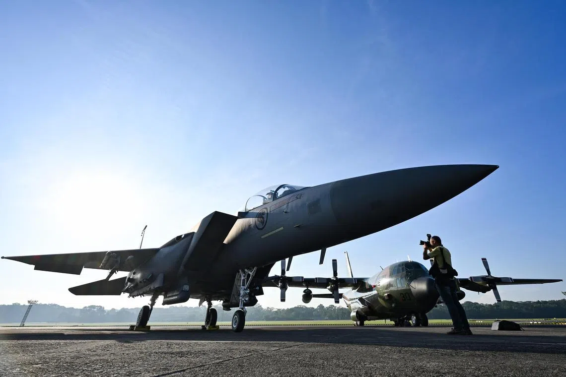 [Embargoed until 10 Jul (Thu), 1200H.] ST20250704-202585400445-Lim Yaohui-Gabrielle Chan-gcndp10/ F-15SG all-weather multi-role fighter and C-130 Hercules on display during the National Day Parade (NDP) 2025 Air Participation Media Feature at Paya Lebar Air Base on July 4, 2025. Apart from the traditional National Flag flypast, Singaporeans can look forward to witnessing a total of 26 Republic of Singapore Air Force (RSAF) aircraft at National Day Parade (NDP) 2025 in celebration of SG60. (ST PHOTO: LIM YAOHUI)