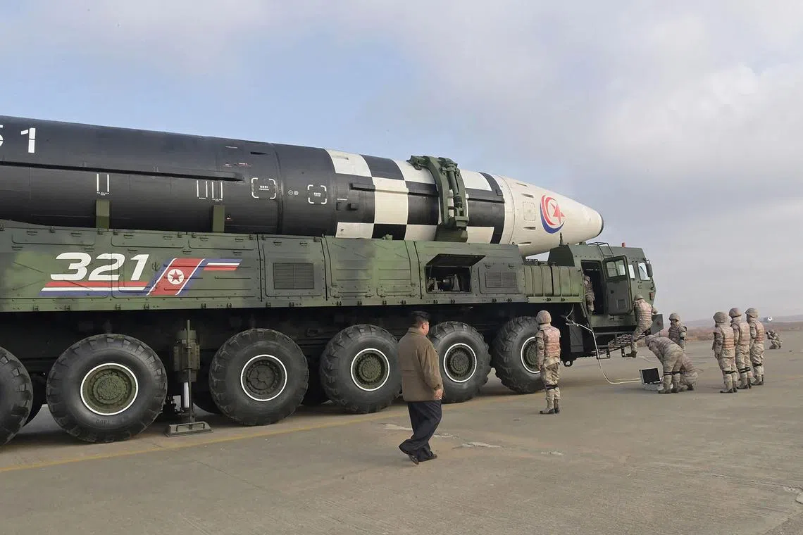 This picture taken on November 18, 2022 and released from North Korea's official Korean Central News Agency (KCNA) on November 19, 2022 shows North Korea's leader Kim Jong Un (L) inspecting a new intercontinental ballistic missile (ICBM) "Hwasong Gun 17", before the launch at Pyongyang International Airport. - North Korean leader Kim Jong Un said he would respond to US threats with nuclear weapons, state media said on November 19, after Kim personally oversaw Pyongyang's latest launch of intercontinental ballistic missile. (Photo by KCNA VIA KNS / AFP) / South Korea OUT / REPUBLIC OF KOREA OUT
---EDITORS NOTE--- RESTRICTED TO EDITORIAL USE - MANDATORY CREDIT "AFP PHOTO/KCNA VIA KNS" - NO MARKETING NO ADVERTISING CAMPAIGNS - DISTRIBUTED AS A SERVICE TO CLIENTS / THIS PICTURE WAS MADE AVAILABLE BY A THIRD PARTY. AFP CAN NOT INDEPENDENTLY VERIFY THE AUTHENTICITY, LOCATION, DATE AND CONTENT OF THIS IMAGE --- / 