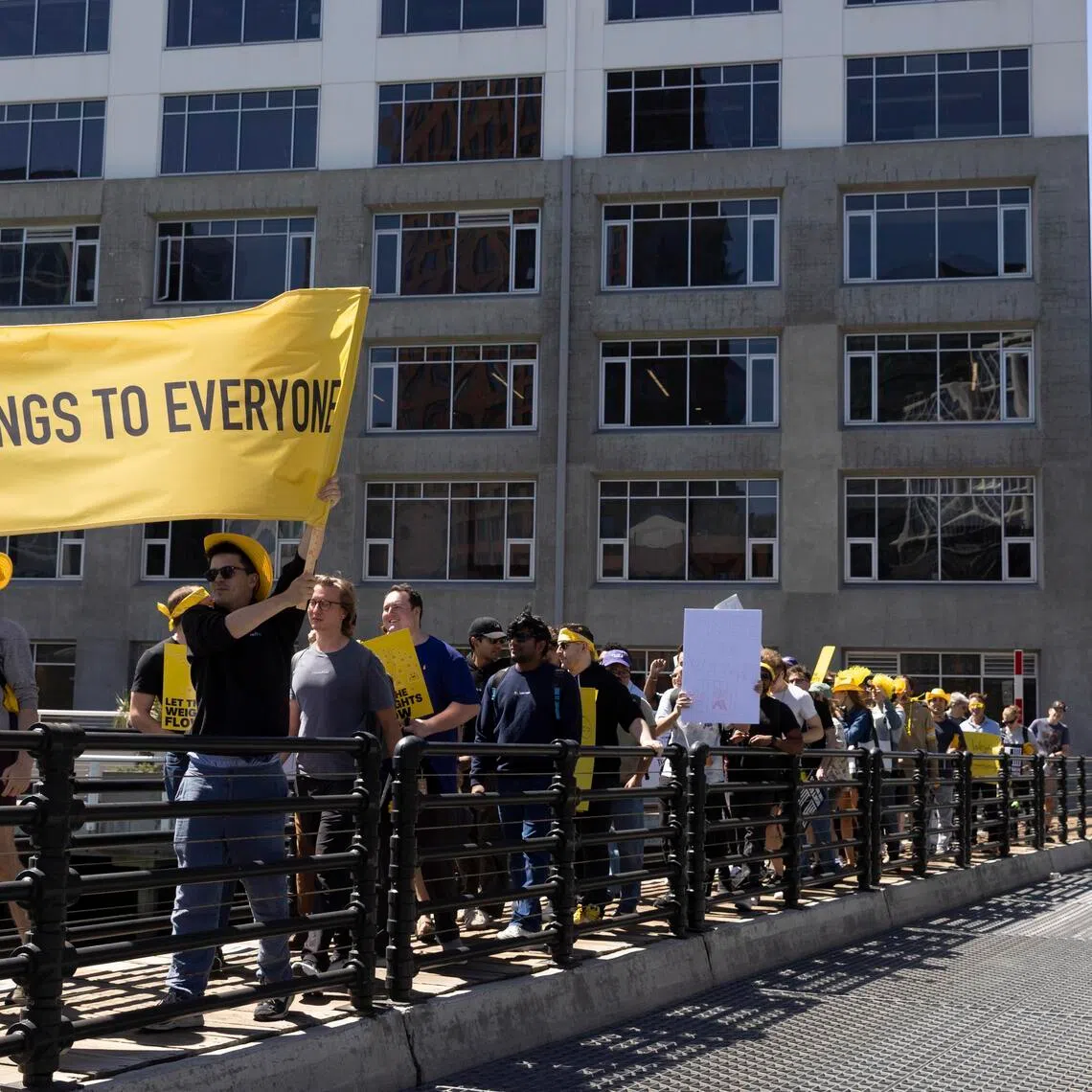 Demonstrators hold a sign that reads ‘AI Belongs to Everyone’ during the Open Weights Mini March in San Francisco, on July 25.