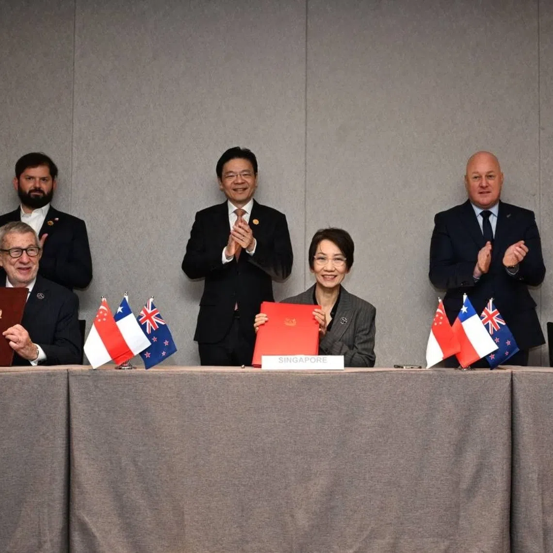 (Seated from left) Chile’s Minister of Foreign Affairs Alberto van Klaveren, Singapore’s Minister for Sustainability and Environment and Minister in Charge of Trade Relations Grace Fu and New Zealand’s Minister for Trade and Investment Todd McClay signing the Green Economy Partnership Agreement (Gepa) on Oct 31. Together with them are (standing from left) Chile President Gabriel Boric, Singapore PM Lawrence Wong and New Zealand PM Christopher Luxon looking.