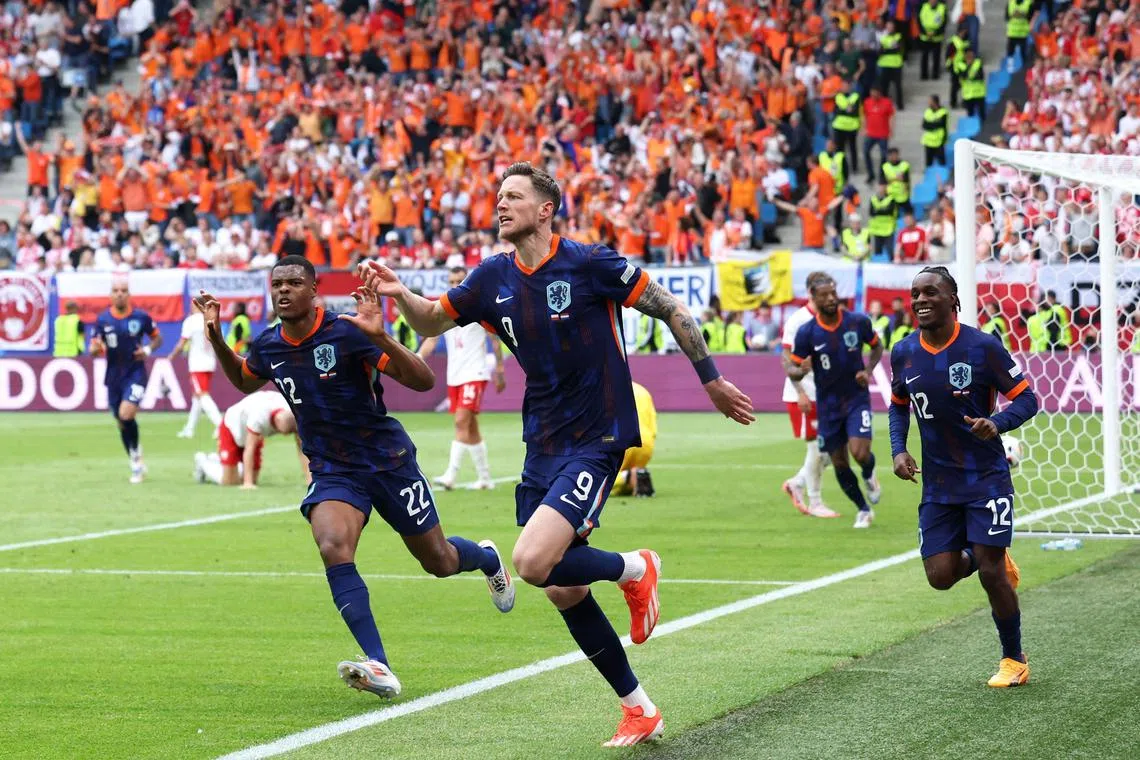 Netherlands forward Wout Weghorst (centre) celebrating after scoring a late winner during the Euro 2024 Group D football match between Poland and the Netherlands at the Volksparkstadion in Hamburg on June 16. The Dutch came back from a goal down to win 2-1.