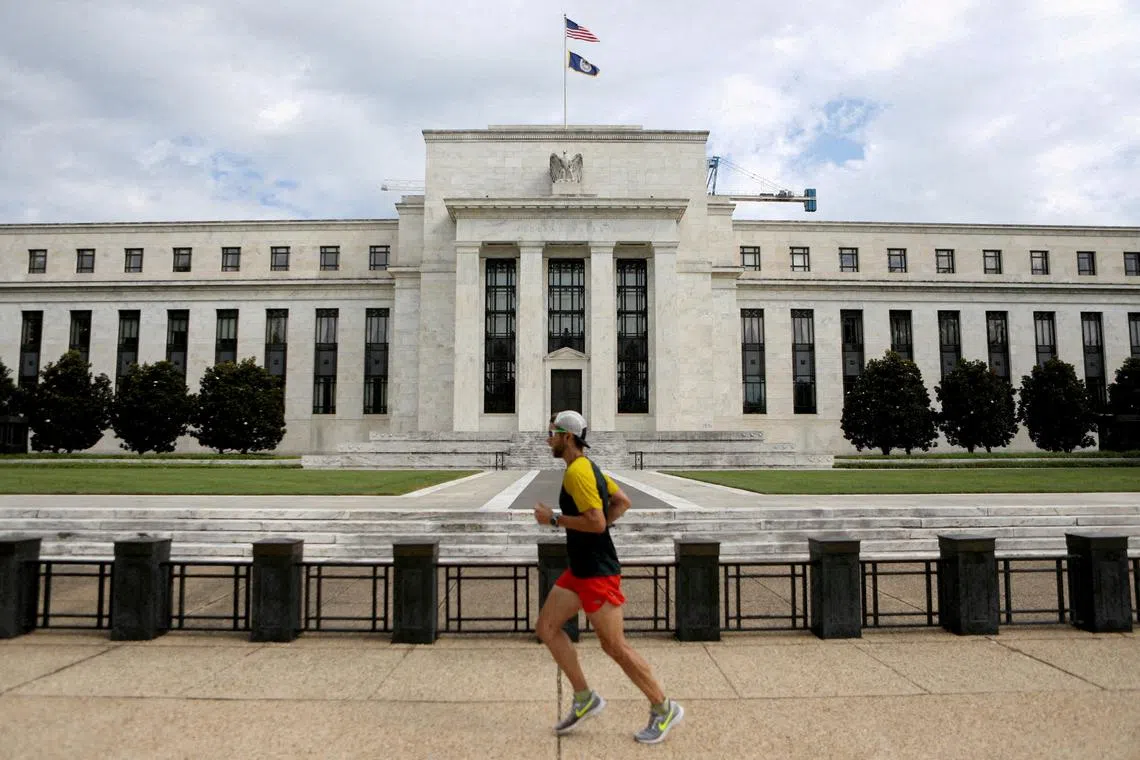 FILE PHOTO: A jogger runs past the Federal Reserve building in Washington, DC, U.S., August 22, 2018. REUTERS/Chris Wattie/File Photo