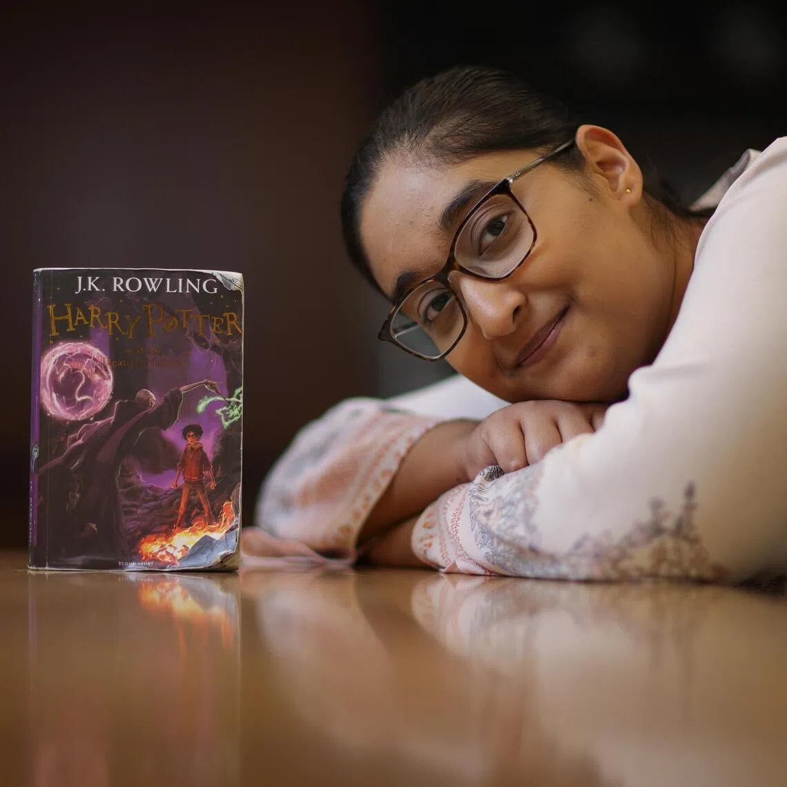 The writer with her copy of Harry Potter and the Deathly Hallows, which she is intentionally taking her time to finish.