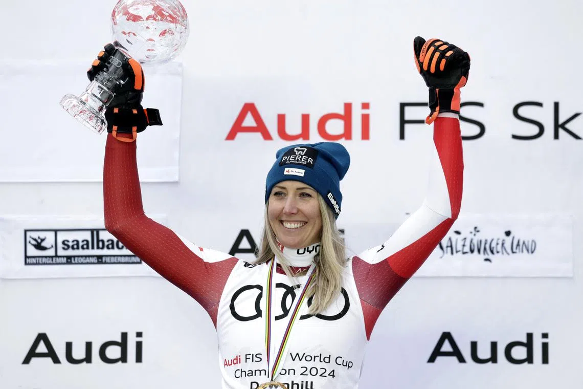 Alpine Skiing - FIS Alpine Ski World Cup - Women's Downhill - Saalbach, Austria - March 23, 2024 Austria's Cornelia Huetter celebrates on the podium with the crystal globe after winning the women's downhill overall REUTERS/Leonhard Foeger