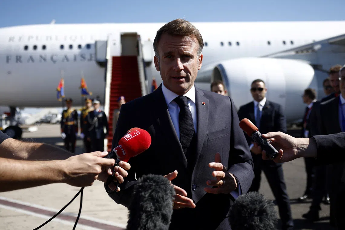 French President Emmanuel Macron speaks to the members of the media, after arriving by plane to attend the Gaza Peace Summit, in Sharm el-Sheikh, Egypt, October 13, 2025. Yoan Valat/Pool via REUTERS