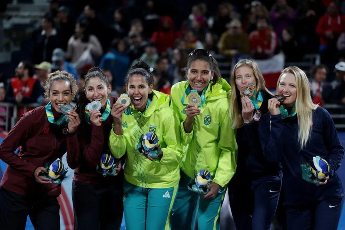 Pan-Am Games - Santiago 2023 - Beach Volleyball - Centro de Voleibol de playa, Santiago, Chile - October 27, 2023 Gold medallist Brazil's Ana Patricia Ramos and Eduarda Santos Lisboa celebrate on the podium after winning the women's teams gold medal match alongside Silver medallist Canada's Melissa Humana-Paredes and Brandie Wilkerson and Bronze medallist Corinne Quiggle and Sarah Murph of the U.S. REUTERS/Pilar Olivares