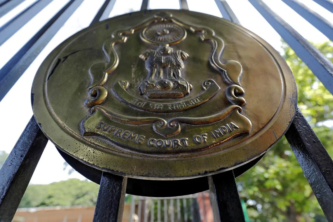 FILE PHOTO: The emblem of the Supreme Court is seen on a gate of the court in New Delhi, India, September 28, 2018. REUTERS/Anushree Fadnavis/File Photo