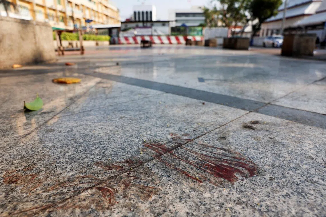 Blood stains the ground at the scene where a former politician with now-dissolved Cambodia National Rescue Party (CNRP) Lim Kimya, 74, was shot dead, in Bangkok.