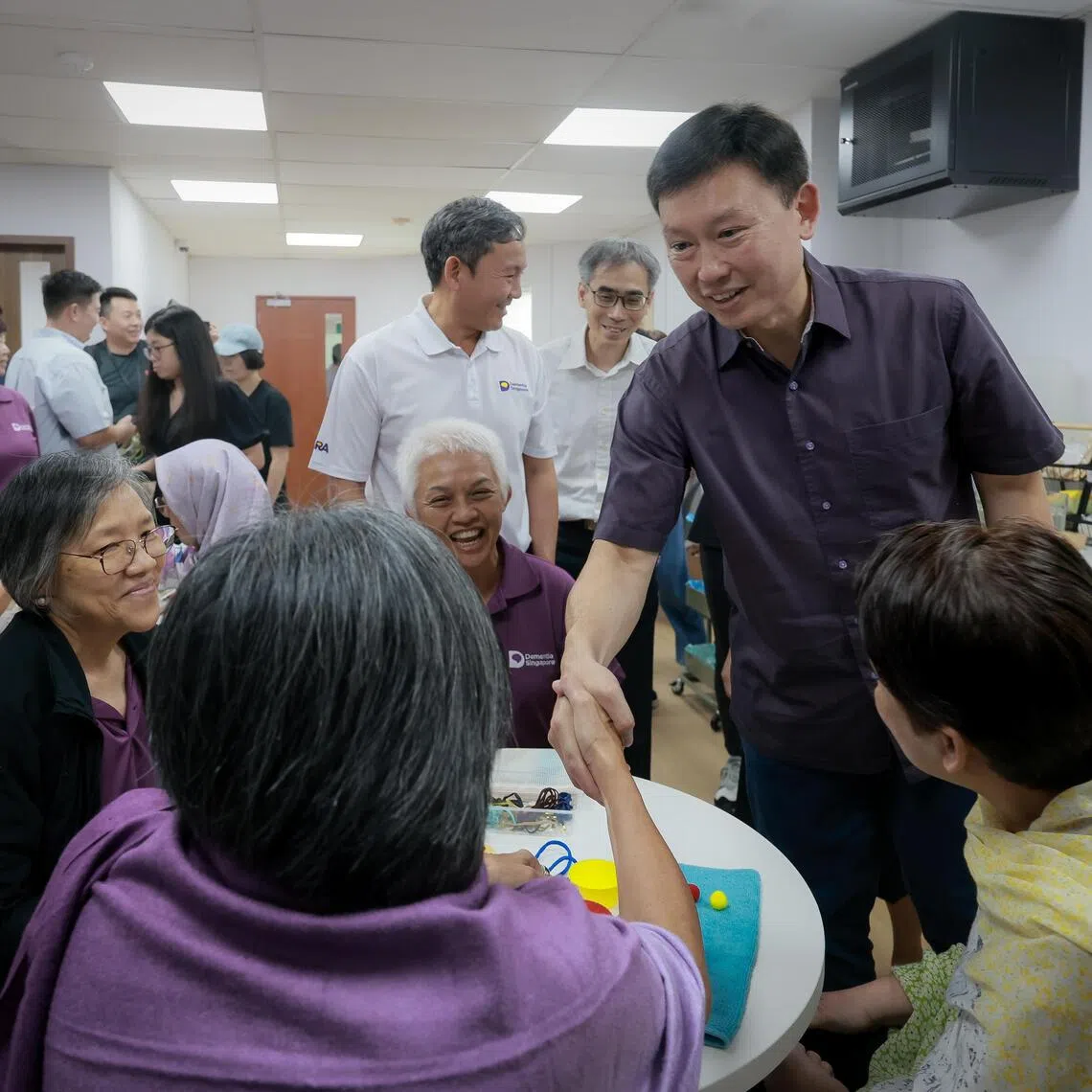 National Development Minister Chee Hong Tat shakes hands with a Voices for Hope alumnus during a tour of Dementia Singapore’s first Voices for Hope Centre on Oct 3.