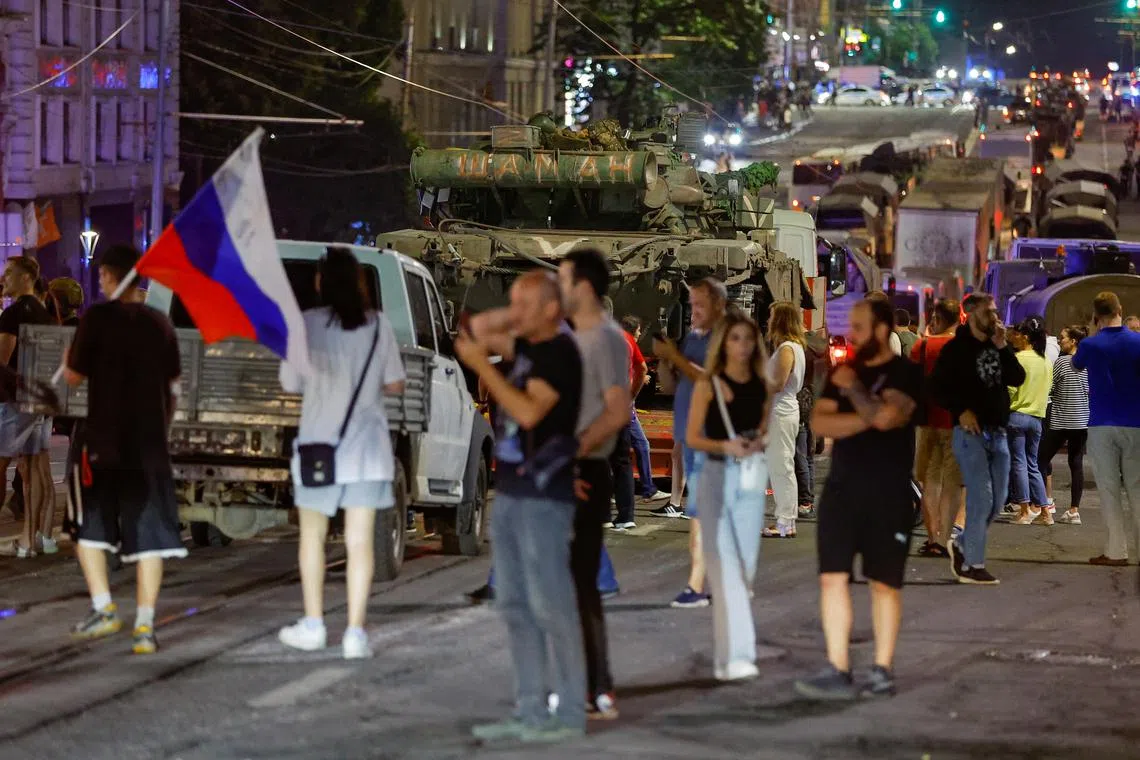 People gather on streets after fighters of the Wagner group pull out of the headquarters of the Southern Military District to return to base, on June 24.
