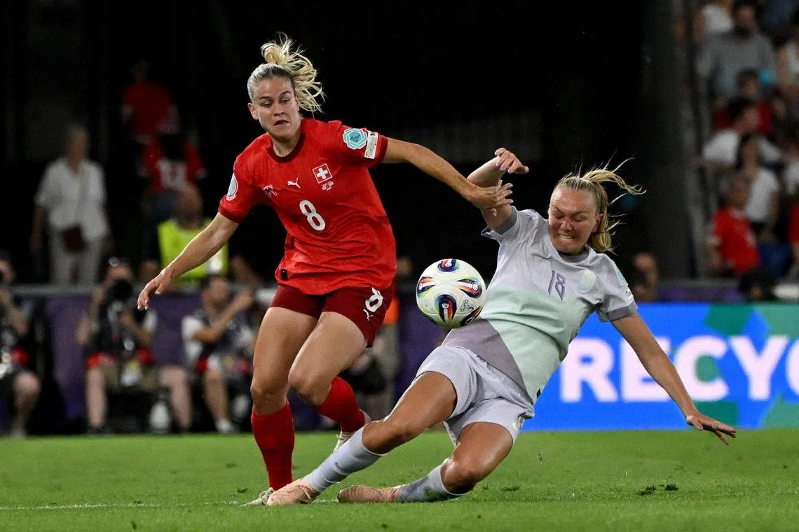 Switzerland defender Nadine Riesen and Norway midfielder Frida Maanum fight for the ball.
