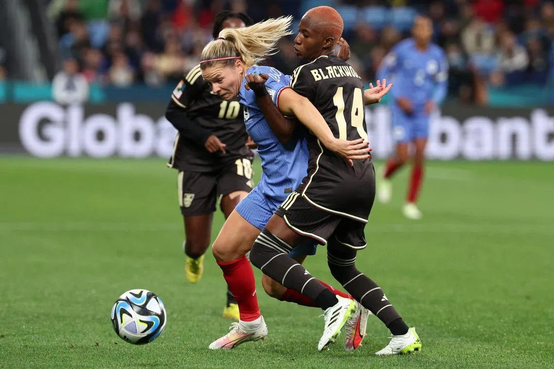 Jamaica defender Deneisha Blackwood fights for the ball with France forward Eugenie Le Sommer during their Women's World Cup match.