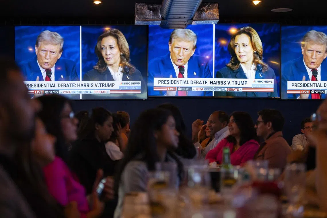 People watch the presidential debate between former president Donald Trump and Vice-President Kamala Harris, in New York, on Sept 10.