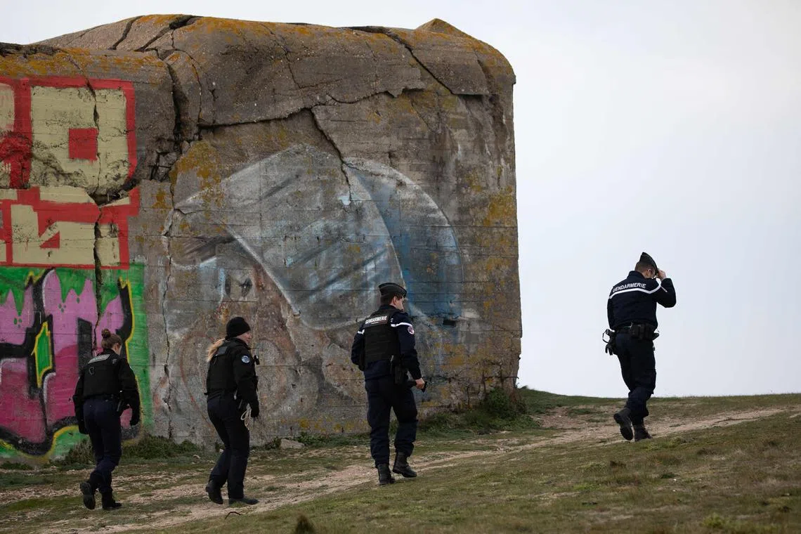 French police officers patrol a beach in northwestern France, where more than two tonnes of cocaine packed in bags washed up. 