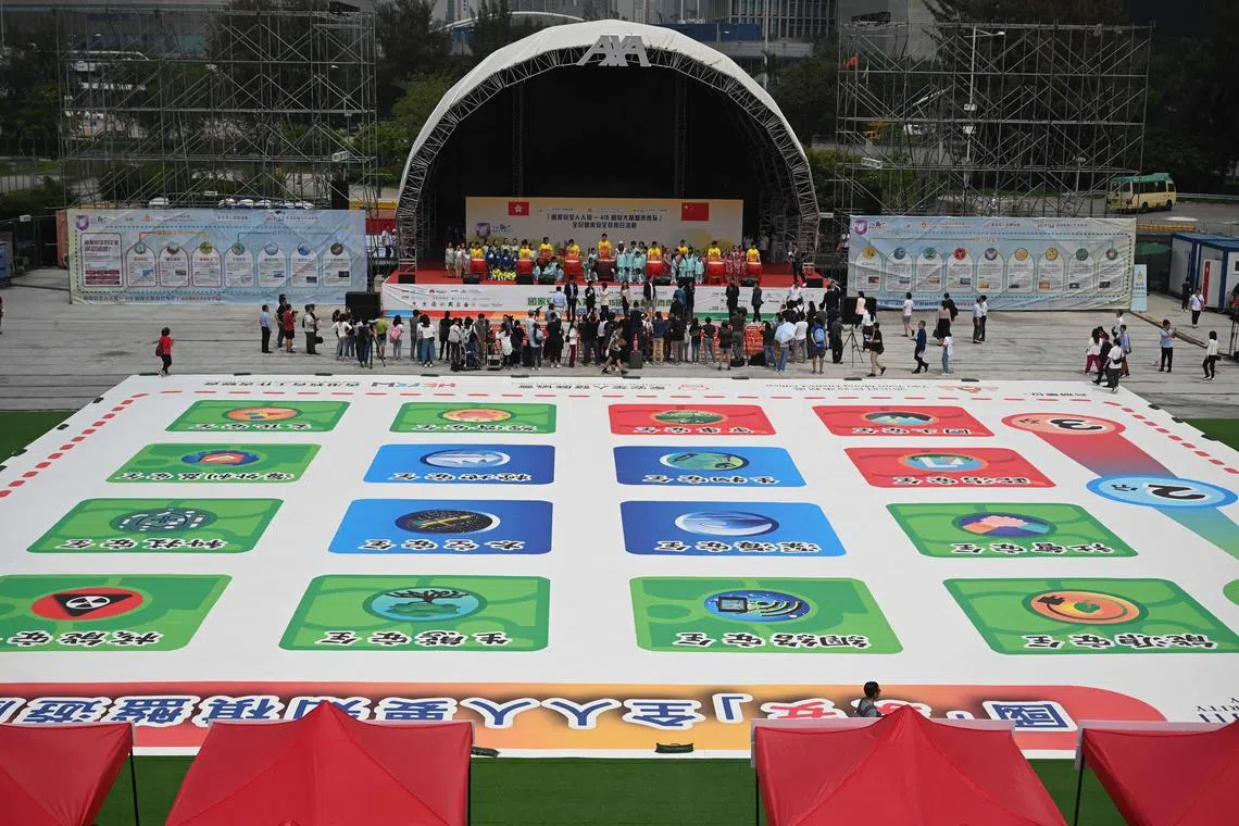 Children playing a giant board game on National Security Education Day in Hong Kong on April 15, 2023. 