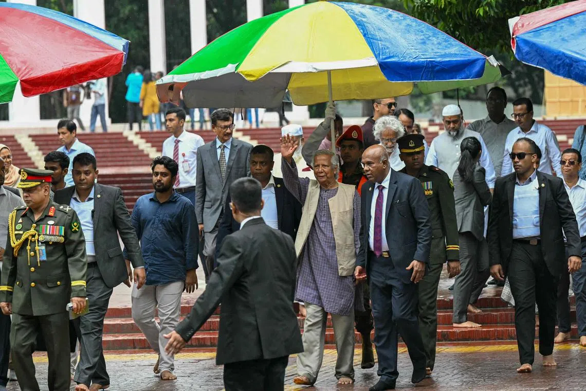 Dr Yunus (centre) greets the public after laying a wreath at the National Martyrs' Memorial in Dhaka.