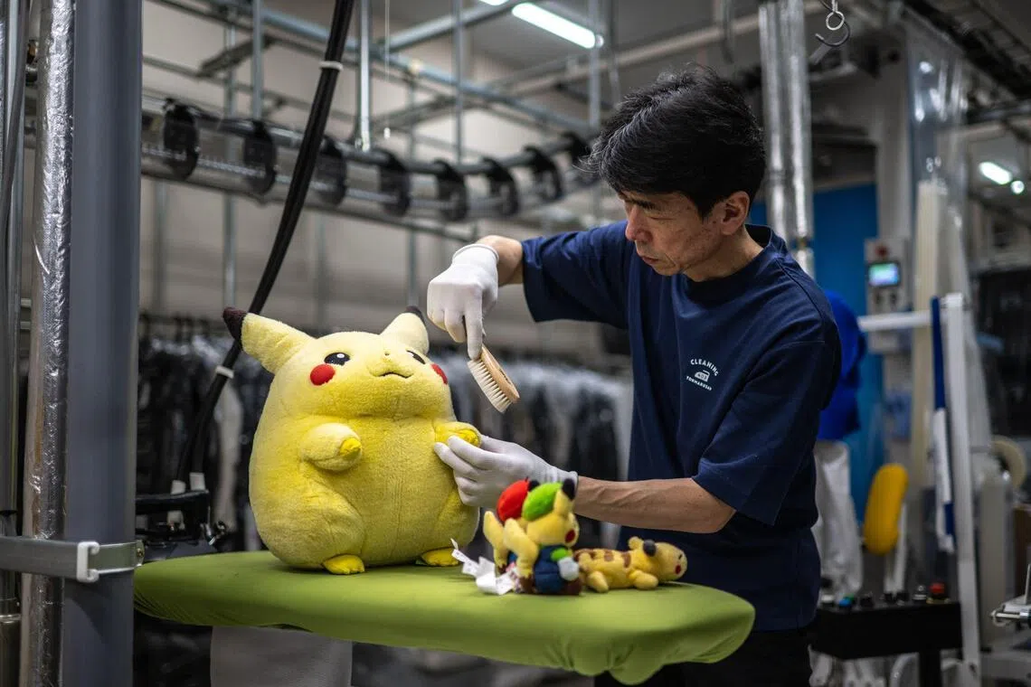 Dry-cleaning professional Masakazu Shimura brushes a soft toy at the facility of Cleaning Yonmarusan in Fuefuki city of Yamanashi Prefecture.