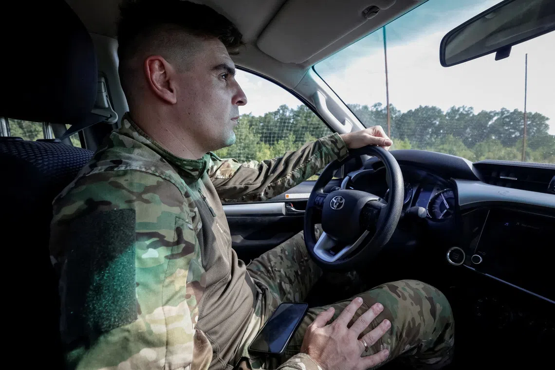 Ukrainian commander Vladyslav Polskyi, 29, who rescued injured service members from an unmanned ground vehicle (UGV) and earned nation's highest military honour, the Hero of Ukraine, drives a vehicle, amid Russia's attack on Ukraine, in Kharkiv region, Ukraine, August 20, 2026. REUTERS/Sofiia Gatilova