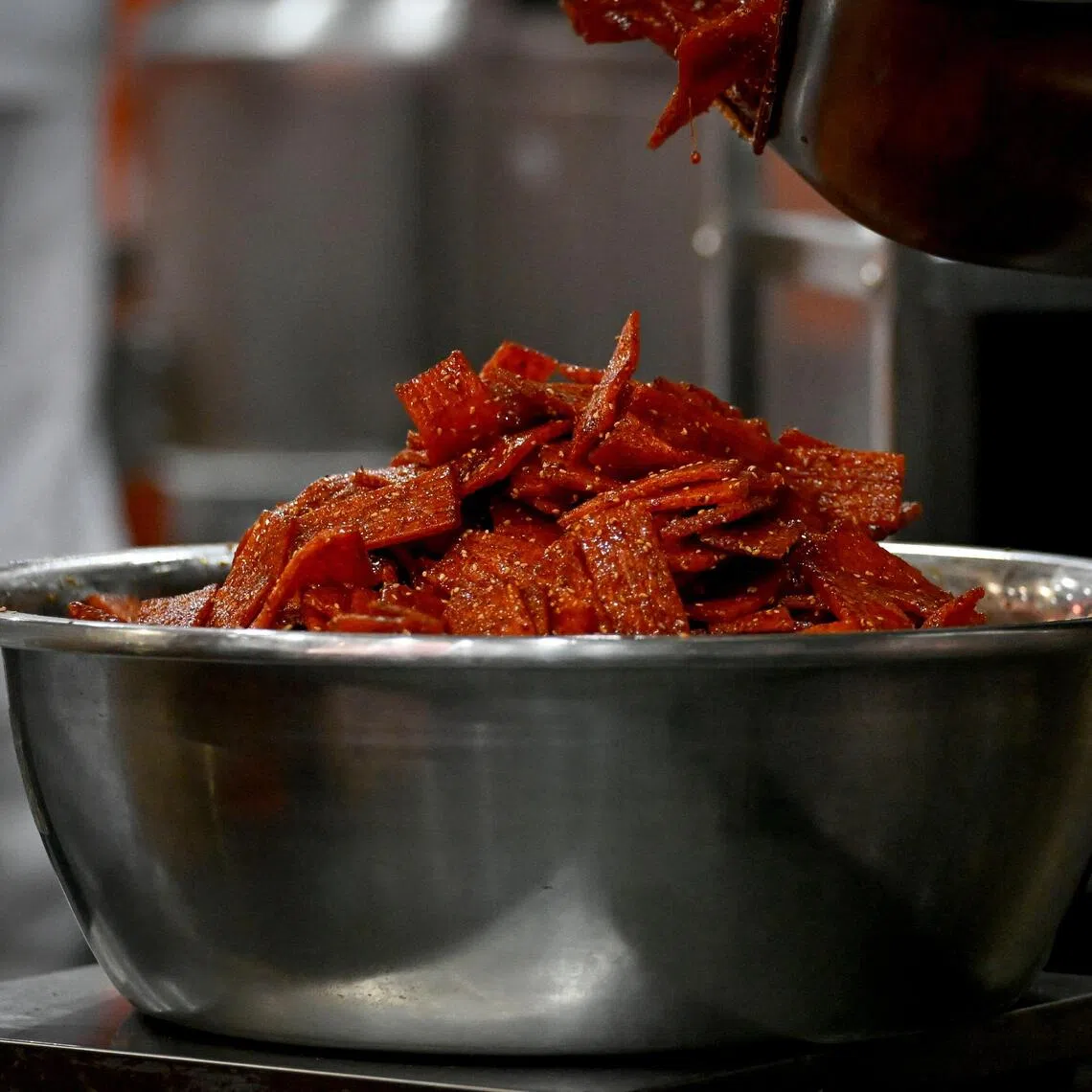 A factory in Pingjiang, China, turns out nearly 700 tonnes of spongy, red-coloured latiao, or spicy strips, a day.