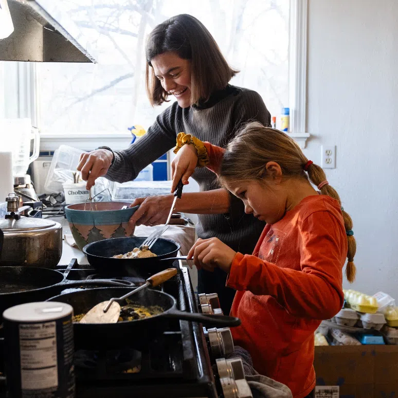 Parenting expert Michaeleen Doucleff cooking pancakes with her daughter, Rosy, at home.