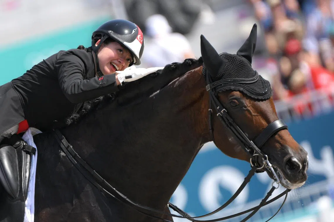 Caroline Chew pats her horse Zatchmo after completing her dressage event at the Paris Olympics. 