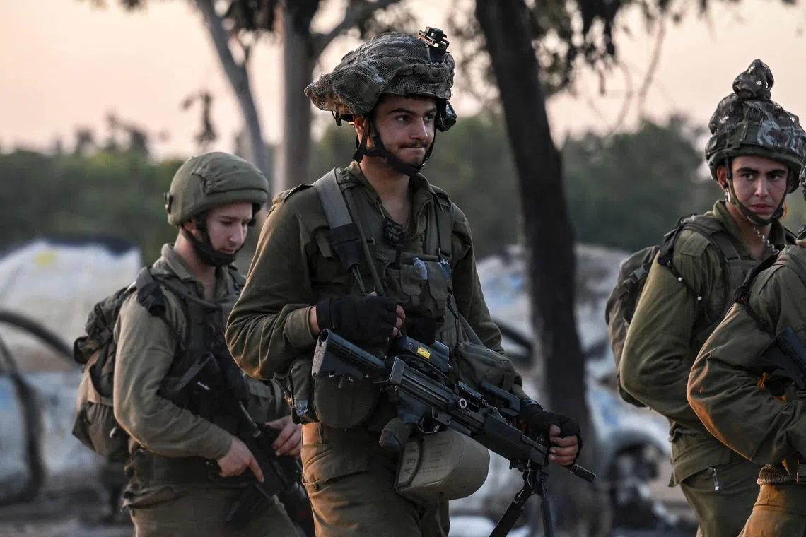 Israeli soldiers patrol near Kibbutz Beeri, the place where 270 revellers were killed by Hamas militants during the Supernova music festival.