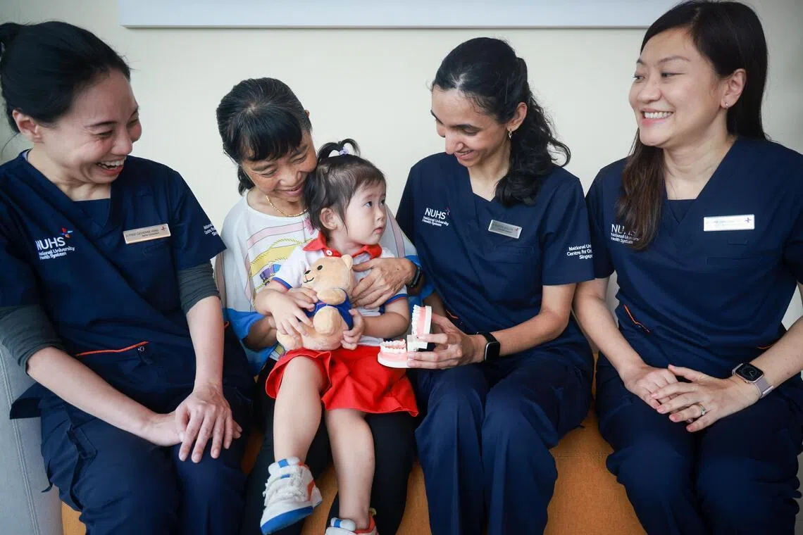 (From left) A/Prof Catherine Hong, Vice Dean (Research, Innovation and Enterprise), NUS Dentistry and Senior Consultant, Division of Paediatric Dentistry, NUCOHS, Mdm Peggy Tan and her granddaughter Rhianne Lee, HEADS-UPP tele-dentistry programme participant, Dr Ishreen Dhillon, Associate Consultant, Division of Paediatric Dentistry, NUCOHS and Academic Fellow, NUS Dentistry, Adj A/Prof Chong Shang Chee, Head of Division and Senior Consultant, Division of Developmental and Behavioural Paediatrics, Department of Paediatrics, Khoo Teck Puat-National University Children's Medical Institute, NUH, and programme lead of HEADS-UPP pictured April 22, 2026.