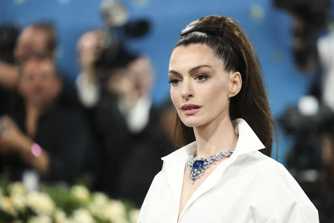 FILE PHOTO: Anne Hathaway poses during the Met Gala, an annual fundraising gala held for the benefit of the Metropolitan Museum of Art's Costume Institute with this year's theme 'Superfine: Tailoring Black Style,' in New York City, New York, U.S., May 5, 2025. REUTERS/Mario Anzuoni/File Photo