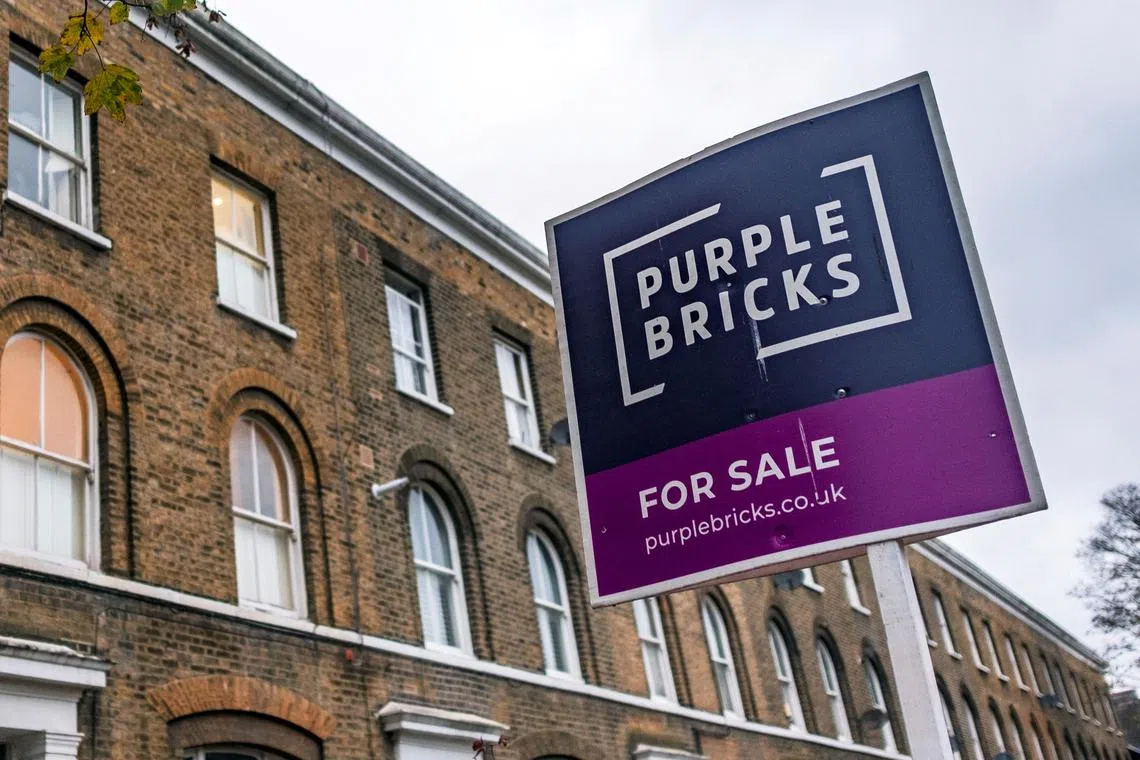 FILE PHOTO: A sign for online estate agent Purplebricks is pictured outside a property in a residential street in London, Britain, November 24, 2021. Picture taken November 24, 2021.    REUTERS/May James/File Photo