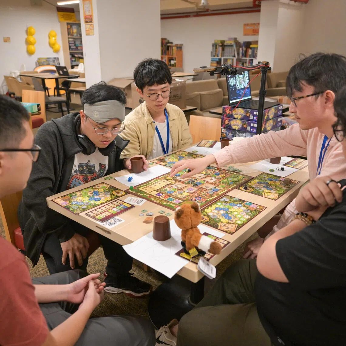 Players participating at the World Series of Board Gaming Singapore satellite event final game at The Mind Cafe Mega Store on June 2, 2025.