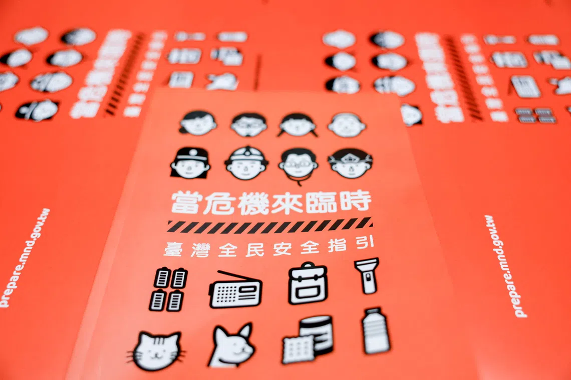 The book cover of Taiwan's civil defence handbook at a printing house in Taoyuan, Taiwan, November 14, 2025. REUTERS/Ann Wang