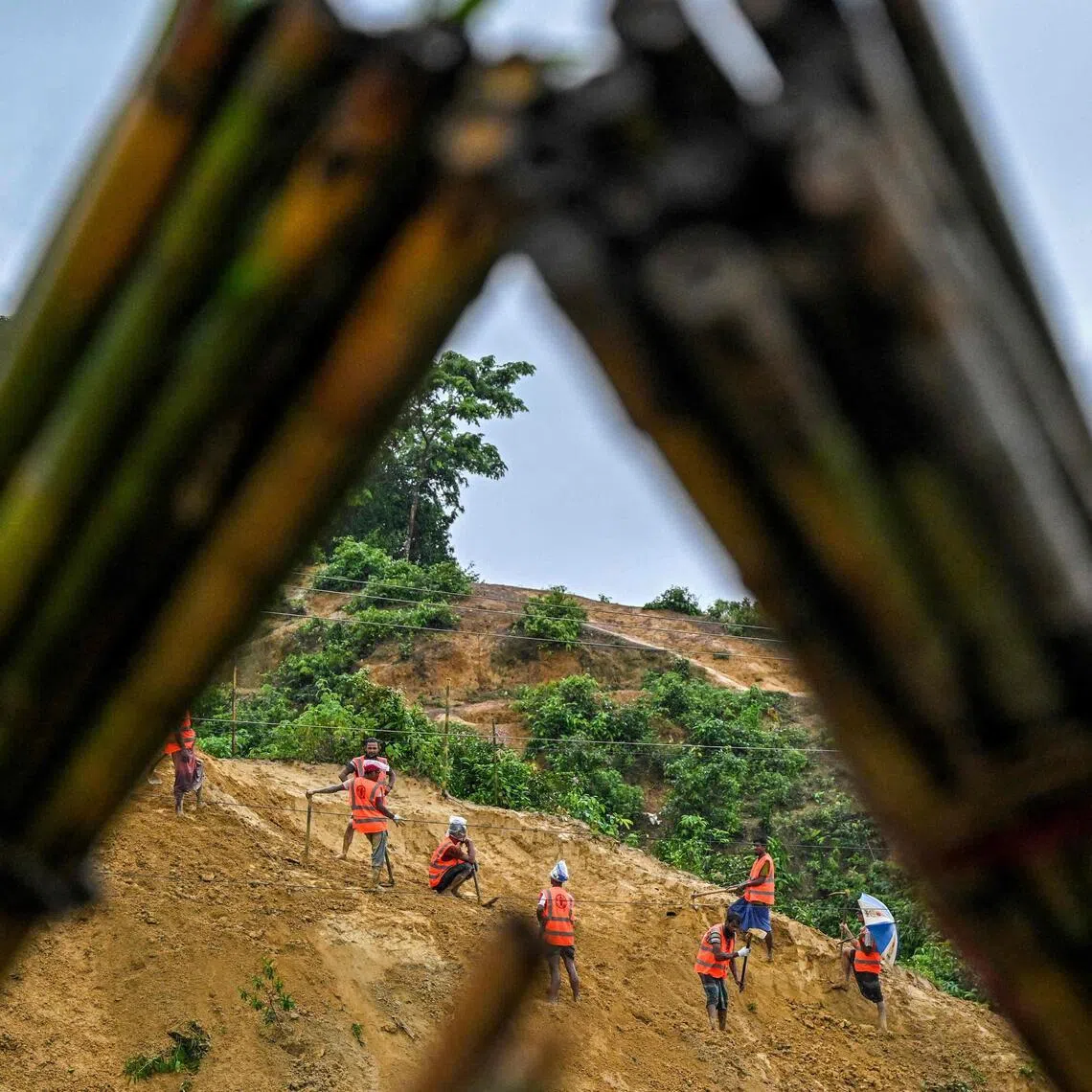 Rohingya refugees preparing a hillside for planting trees at the Kutupalong refugee camp in Bangladesh’s Cox’s Bazar in June.
